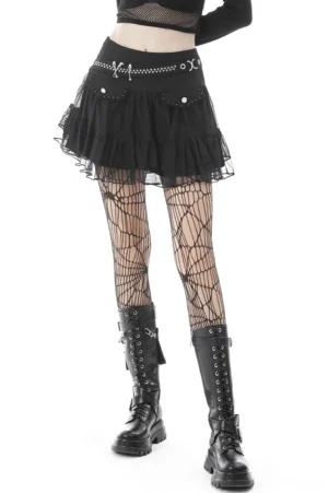 Black gothic pleated mini skirt with skull chain waistband and star studs, three-quarter side view on model