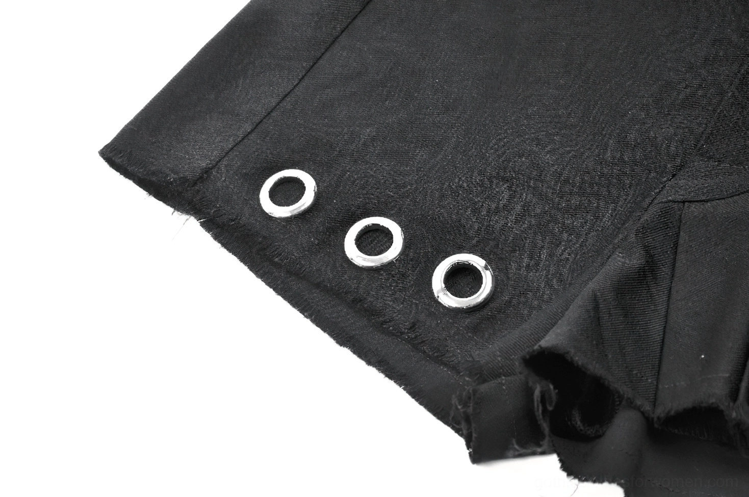 Gothic pleated shorts showcasing asymmetrical pleat construction and metal eyelet accents