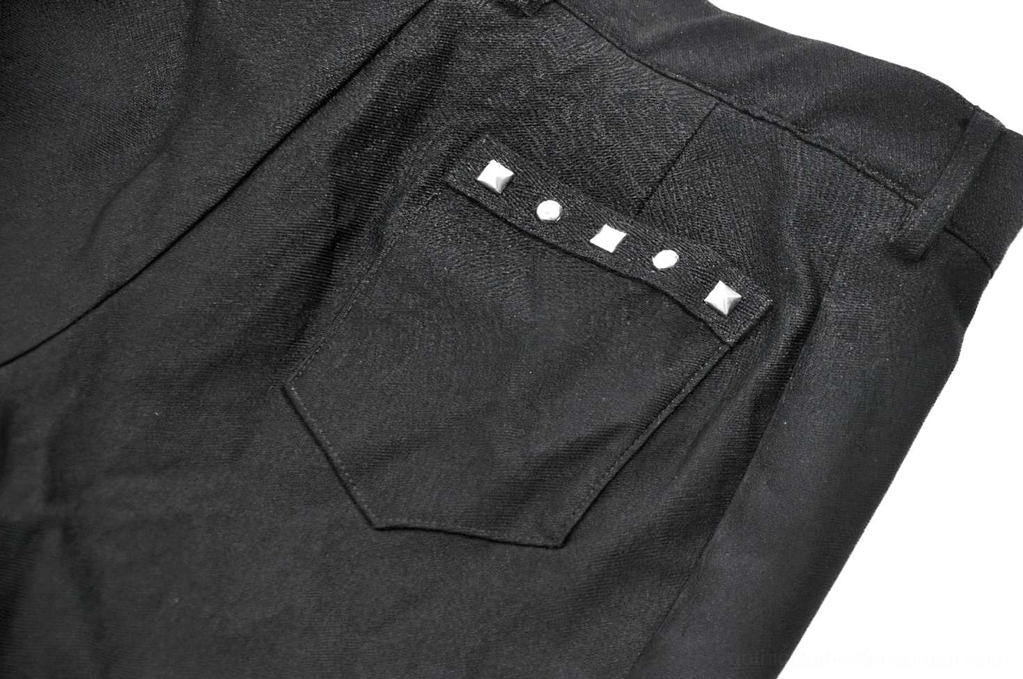 Alternative styling of asymmetrical gothic pleated shorts with accessories on model