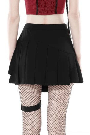 Black pleated punk skirt with leg strap accessory paired with cropped red top, side view styling