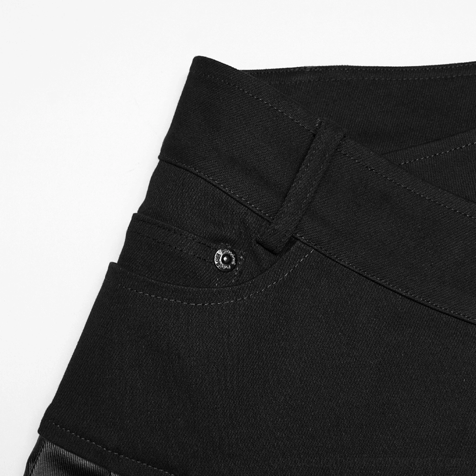 Detail shot of black gothic pleated skirt showing pleat texture, architectural fold pattern, and matte faux leather material construction