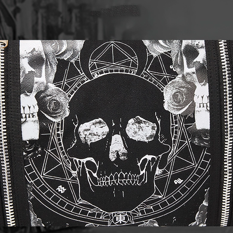 Detailed close-up of skull, rose and pentacle design print on black canvas with metal zipper accents