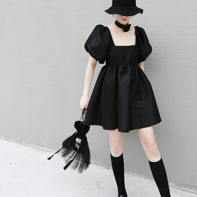 Black gothic dress front side angle on model wearing wide-brim hat and gothic styling