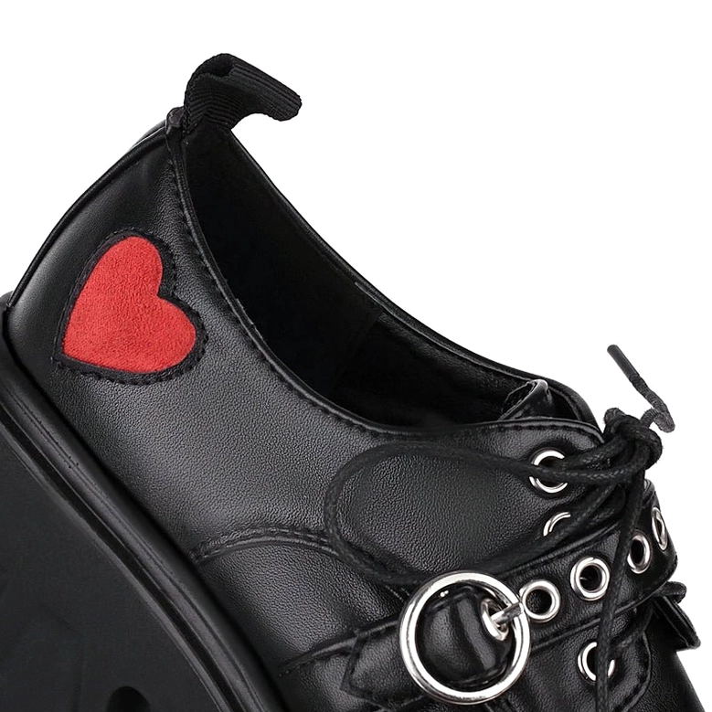 Close-up of gothic pump heel area featuring red heart appliqué and reinforced heel pull tab with black leather finish