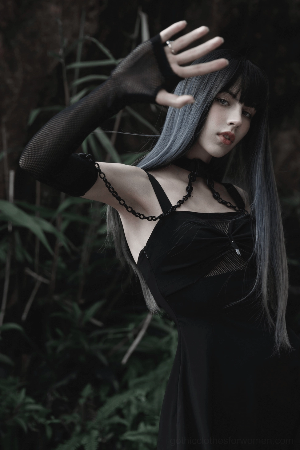 Gothic choker with arm sleeves set on model demonstrating industrial punk-goth aesthetic with metal hardware and transparent fishnet construction