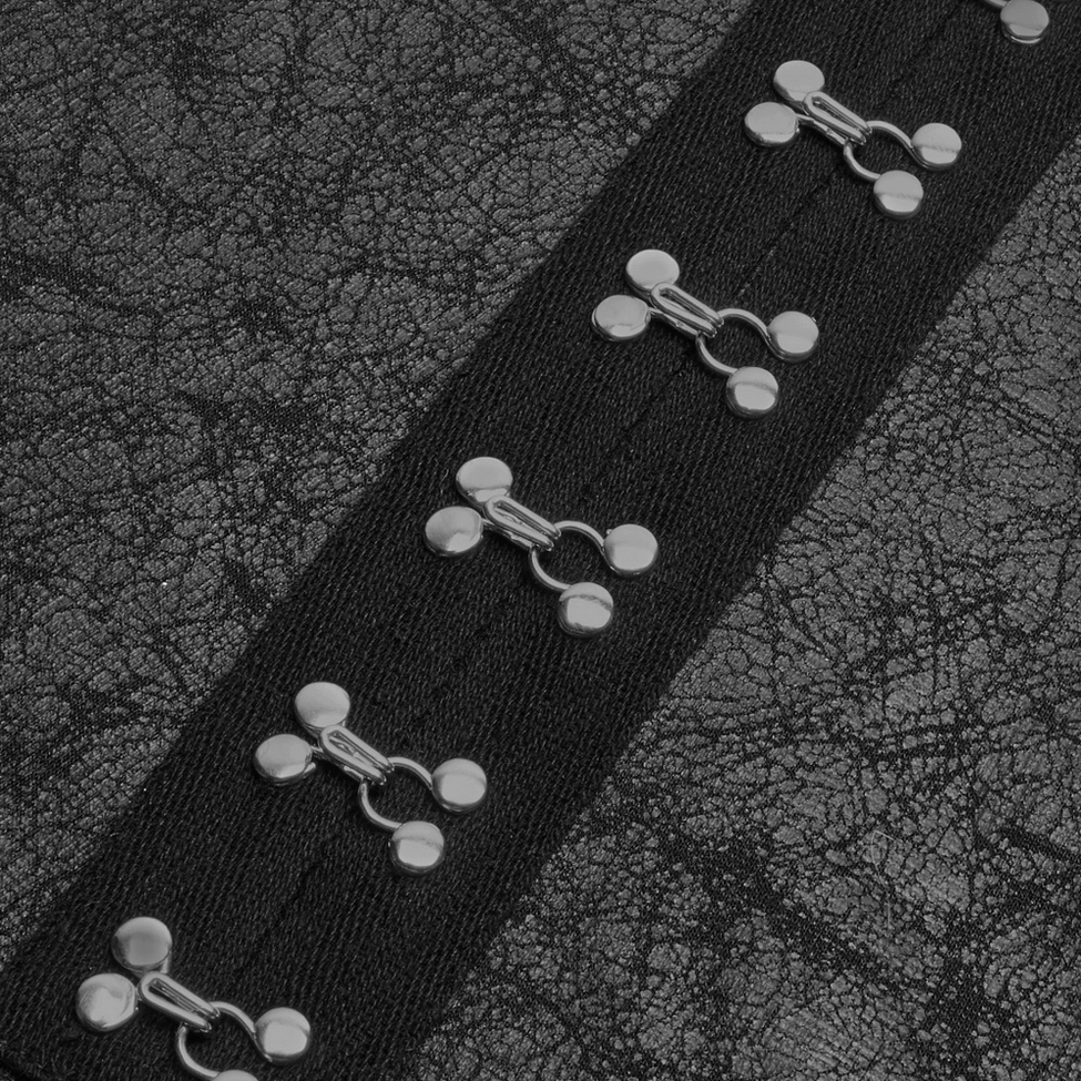 Close-up detail of hook-and-eye closures and black fabric cracked leather texture on gothic punk long coat