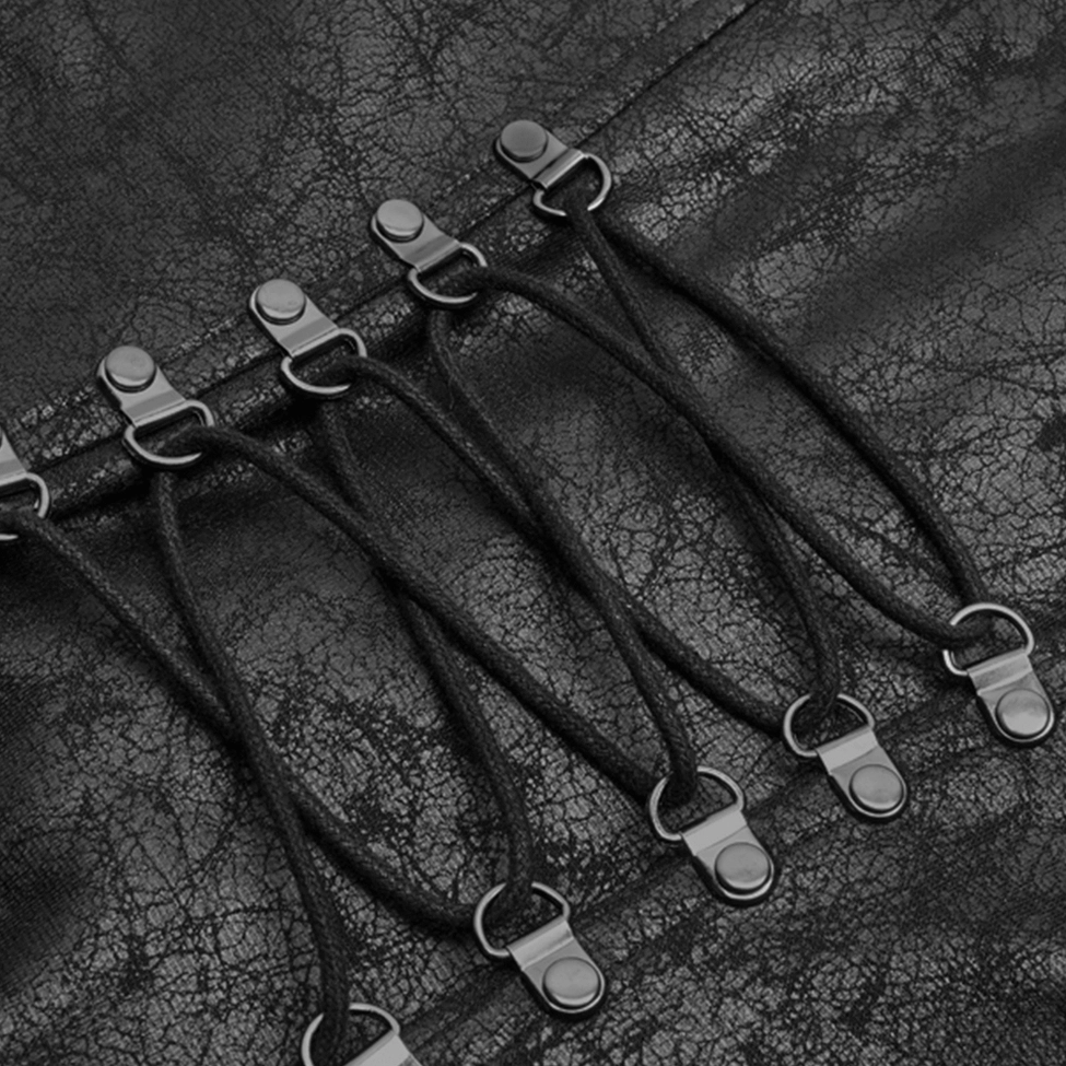 Close-up detail of black lace-up fastener on gothic punk coat with metal buckles and cracked faux leather base texture