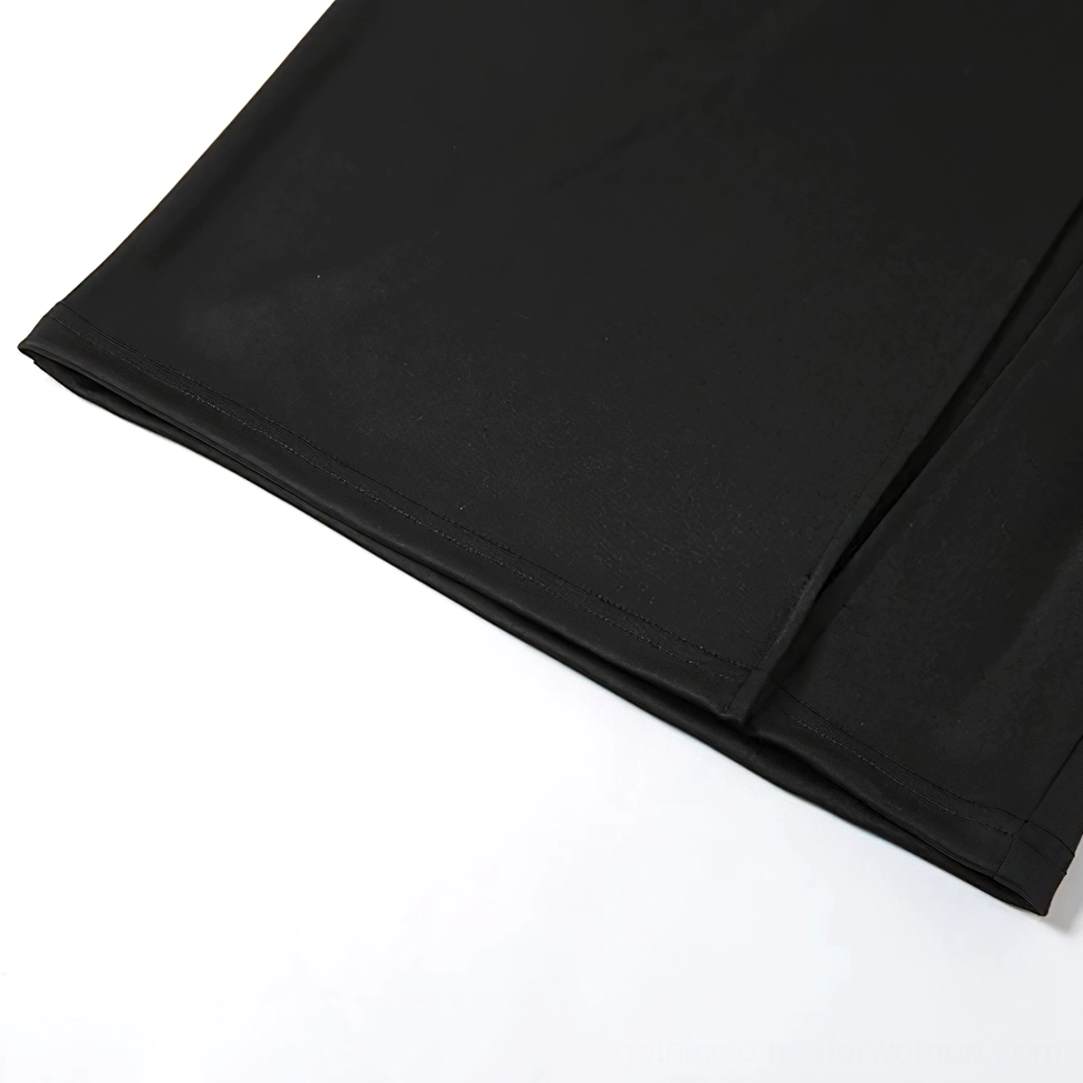 Black midi skirt with safety pins showcasing punk-gothic aesthetic and alternative fashion statement