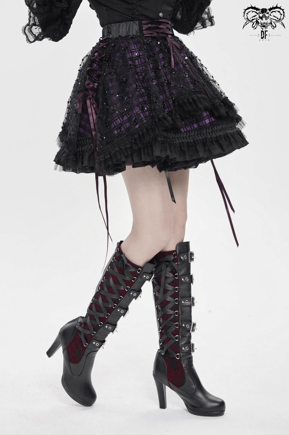 Gothic purple tulle skirt product photography showing complete garment with all design features including ruffled trim and lace-up details visible