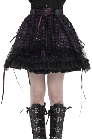 Gothic purple tulle skirt with black sequin mesh overlay and lace-up ribbon trim worn by model in front studio view, showing layered ruffled hem and corset-inspired waist details