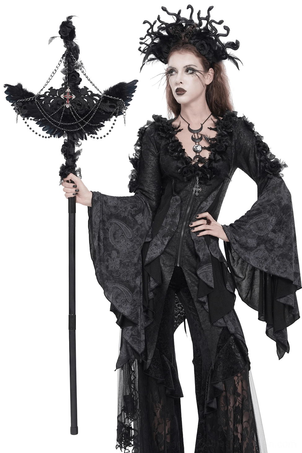 Gothic raven cross staff with roses and beaded chains worn by female model in dark theatrical outfit, three-quarter left side view