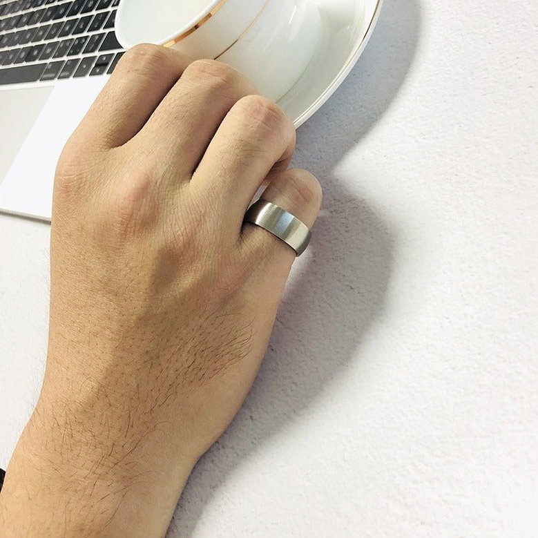 Worn stainless steel black inner gothic ring on male hand, lifestyle wear shot showing professional aesthetic