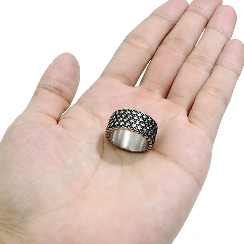Interwoven stainless steel gothic ring displayed on open palm showing true size scale and unisex styling