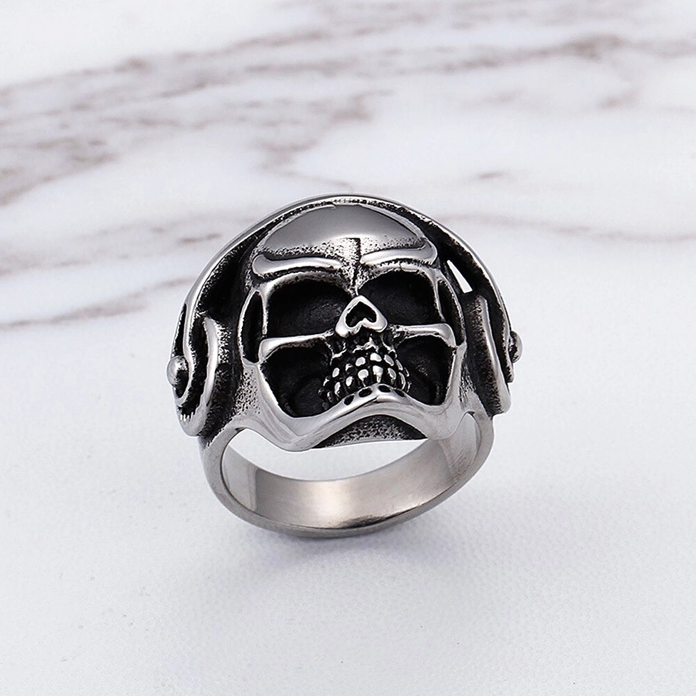 Symmetrical music skull gothic ring top-down view with dual headphone accents