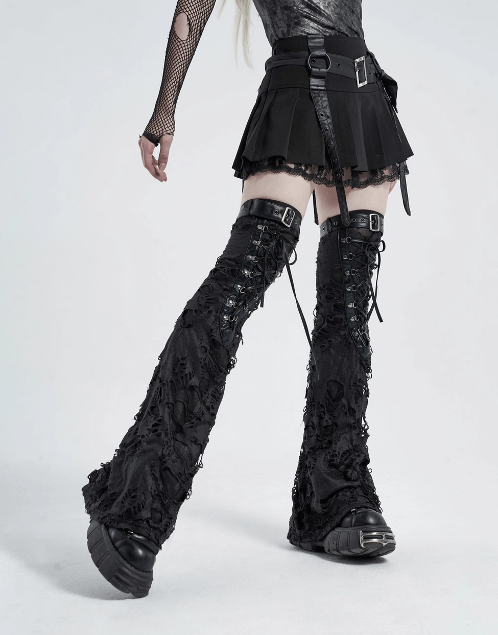Black gothic ripped leg warmers styled with combat boots and alternative fashion outfit on model, complete gothic aesthetic