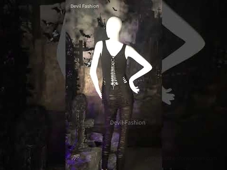 Black gothic ripped pants styled with lace-up corset top and all-black outfit on mannequin