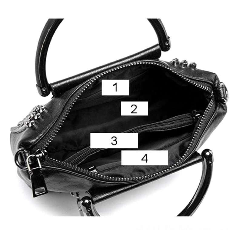 Interior of studded gothic crossbody bag showing black fabric lining and multi-compartment storage with zippered pockets