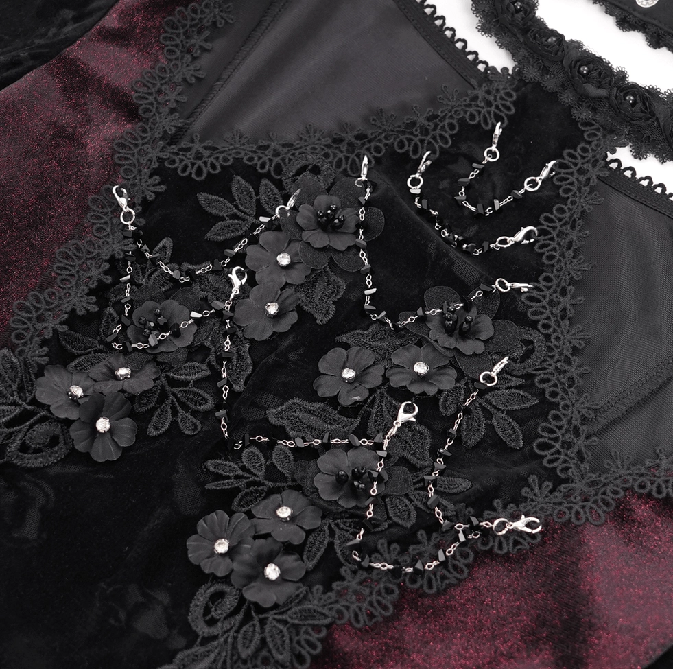 Gothic lace bell sleeve top decoration - macro close-up showing 3D flower appliqués, rhinestone accents, and metal chain embellishments