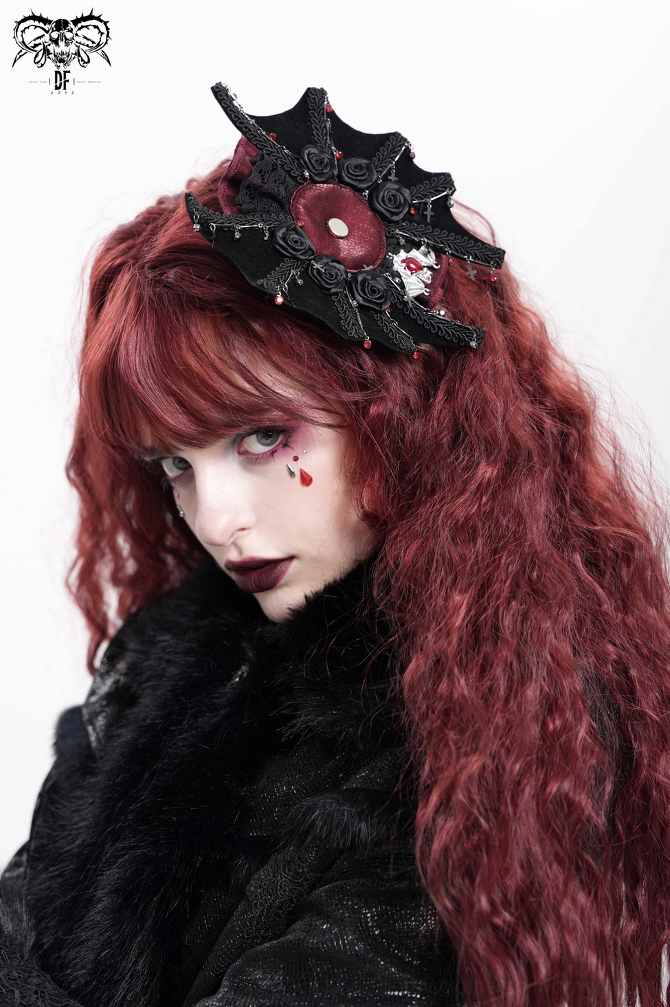 Product detail view of black gothic rose cross hair clip showing complete design with spiderweb lace, skull motif, and burgundy embellishments
