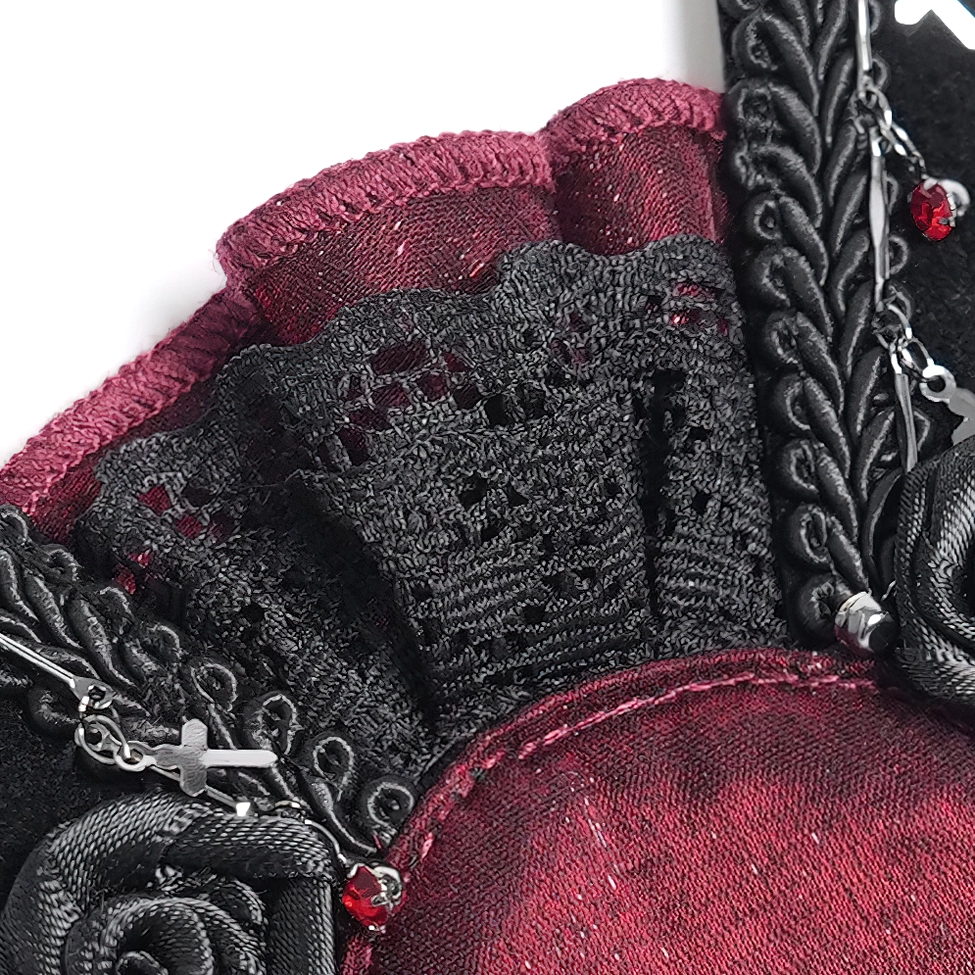 Top detail view of black gothic hair clip edge showing delicate lace trim, woven braid border, and burgundy rhinestone placement