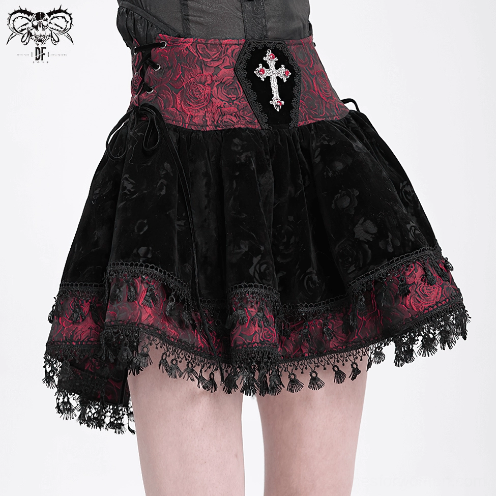 Gothic lace-up velvet skirt detail showing rose jacquard pattern and embroidered cross accent