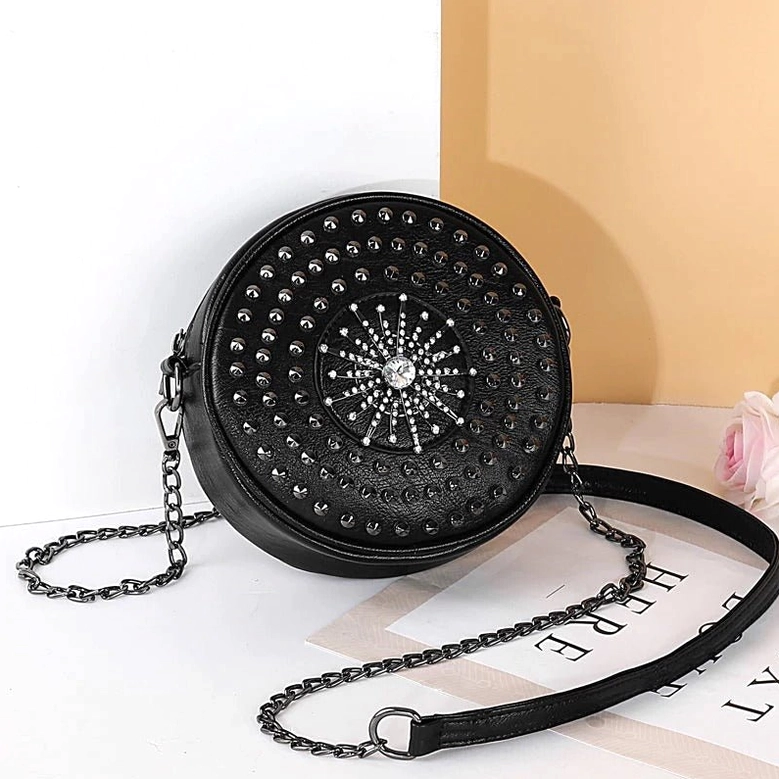 Black rivet crossbody bag oblique side angle with adjustable metal chain leather strap