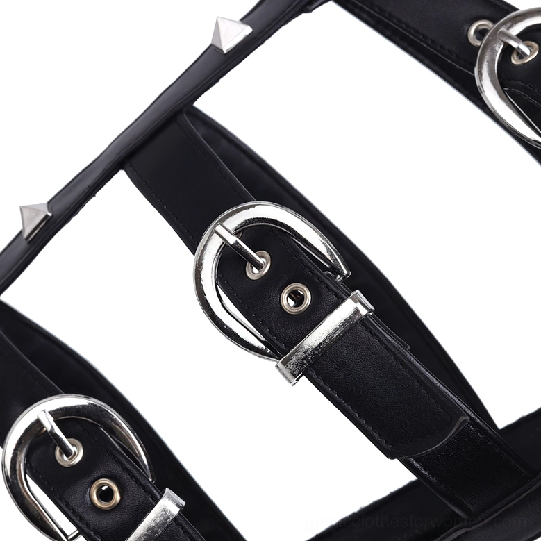 Flat lay close-up of black gothic platform sandal straps and silver hardware, showing D-rings, pyramid studs, and buckle fasteners