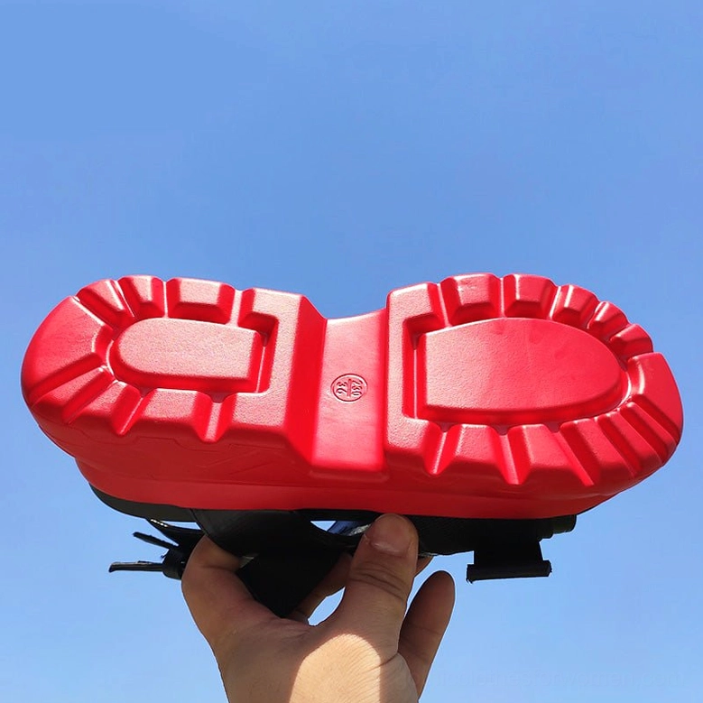 Red rubber platform sandal sole bottom view showing deep lug tread pattern for grip