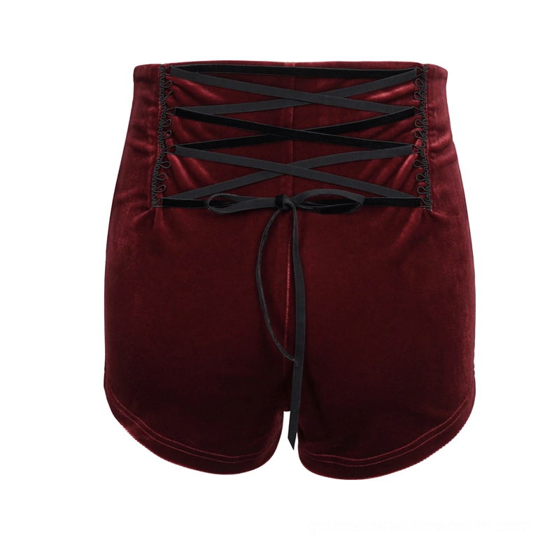 Back flat lay of wine red velvet gothic shorts displaying crisscross lace-up back with bow tie detail