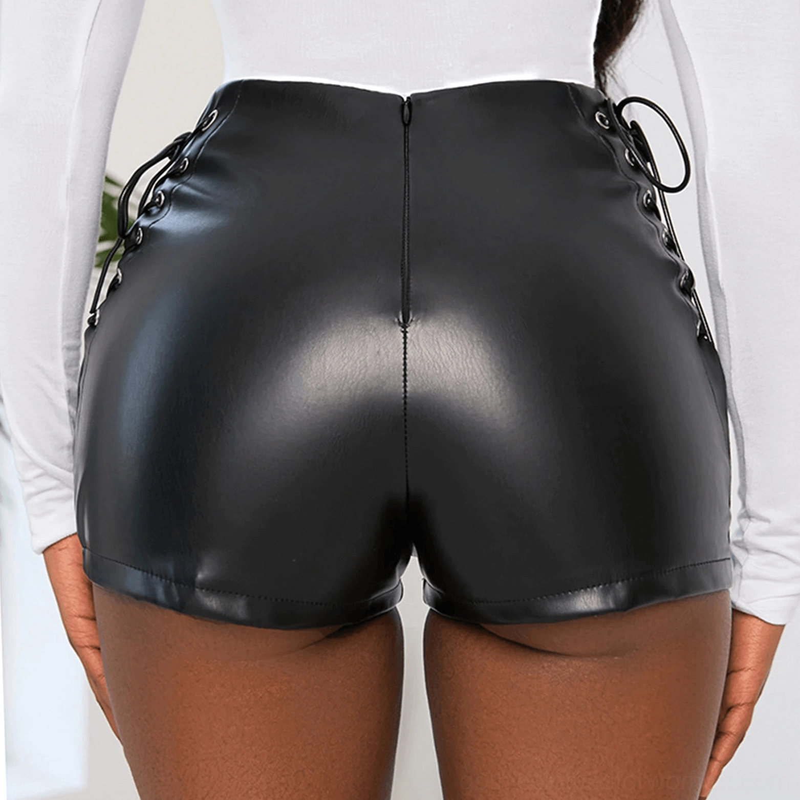 Back full view of black faux leather mini shorts showing rear zipper and side lace-up details