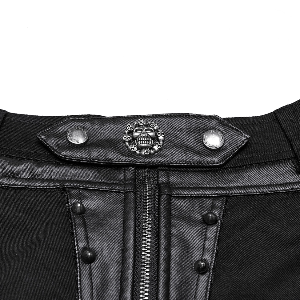 Close-up detail shot of gothic shorts waist area with skull buckle, silver rivets, exposed front zipper, and hardware construction