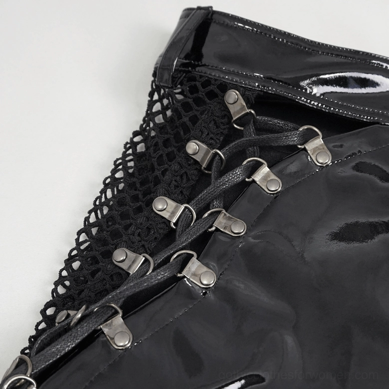 Angled close-up view of gothic shorts showing crisscross metal fasteners, patent leather and mesh fabric combination