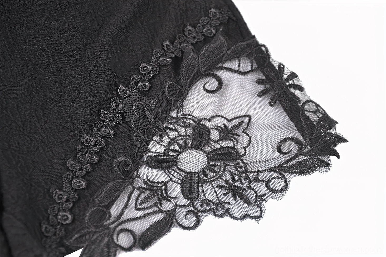 Side embroidery detail of 3D floral lace on black sheer mesh base - lace embroidery macro close-up