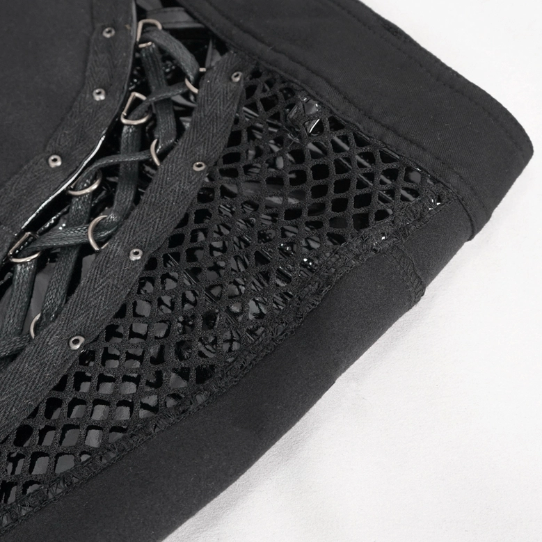Edge close-up view of black mesh panel and metal eyelet strips on gothic shorts with stitched waistband