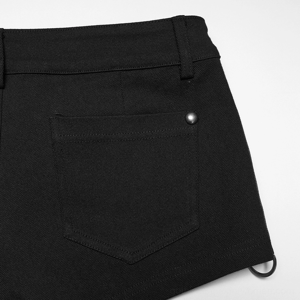 Close-up detail of black gothic shorts back pocket with metal stud fastener, twill fabric, and loop accent