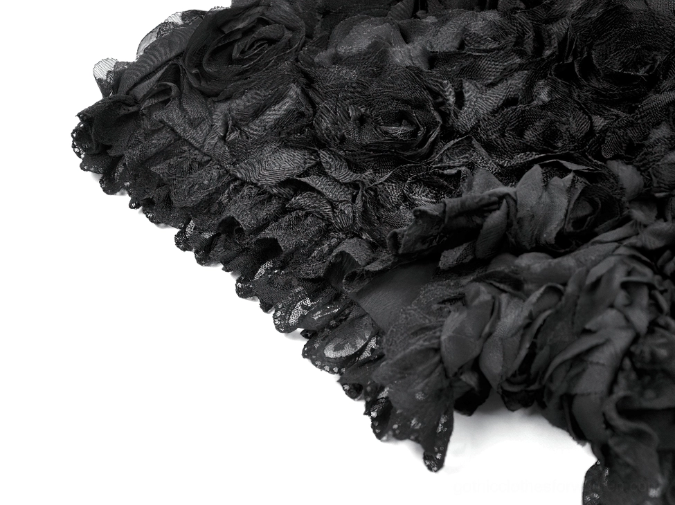 Macro close-up detail of black rose gothic shorts showing layered 3D rose fabric and ruffled lace trim