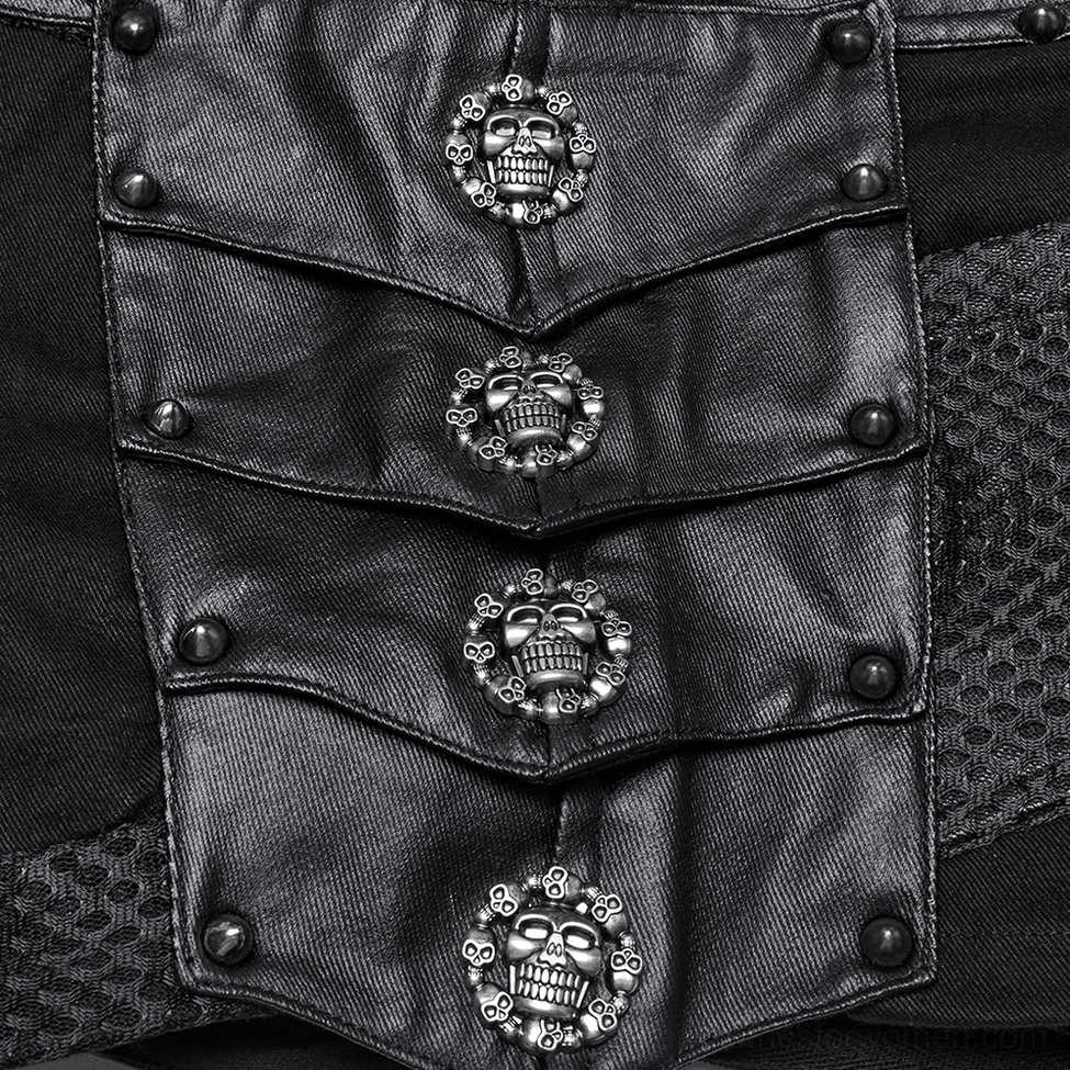 Side close-up detail of gothic shorts showing skull hardware, rivets, mesh fabric panel, and layered armor-fragment design elements