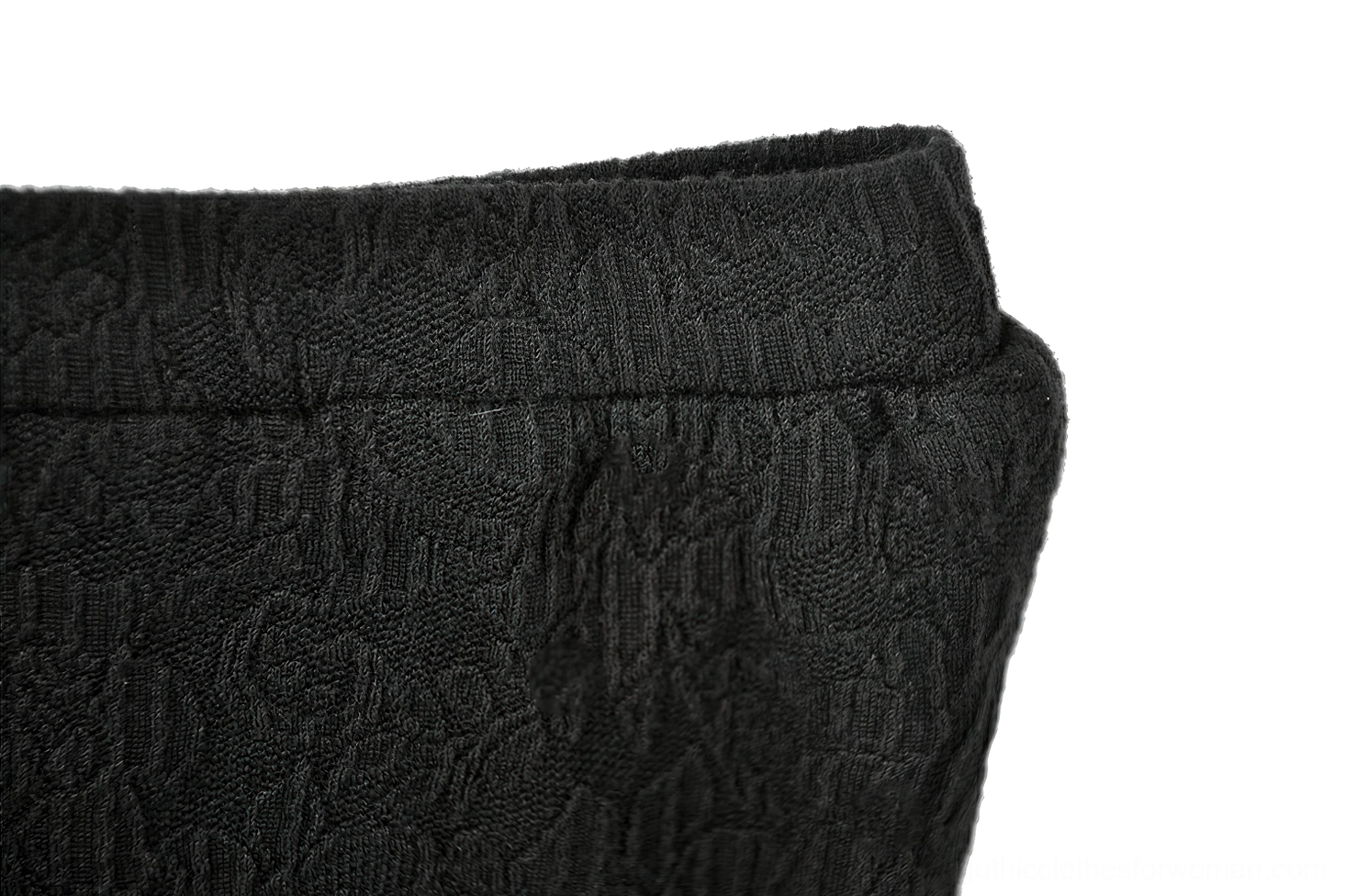 Close-up detail of elastic waistband with subtle jacquard floral pattern - waistband texture macro
