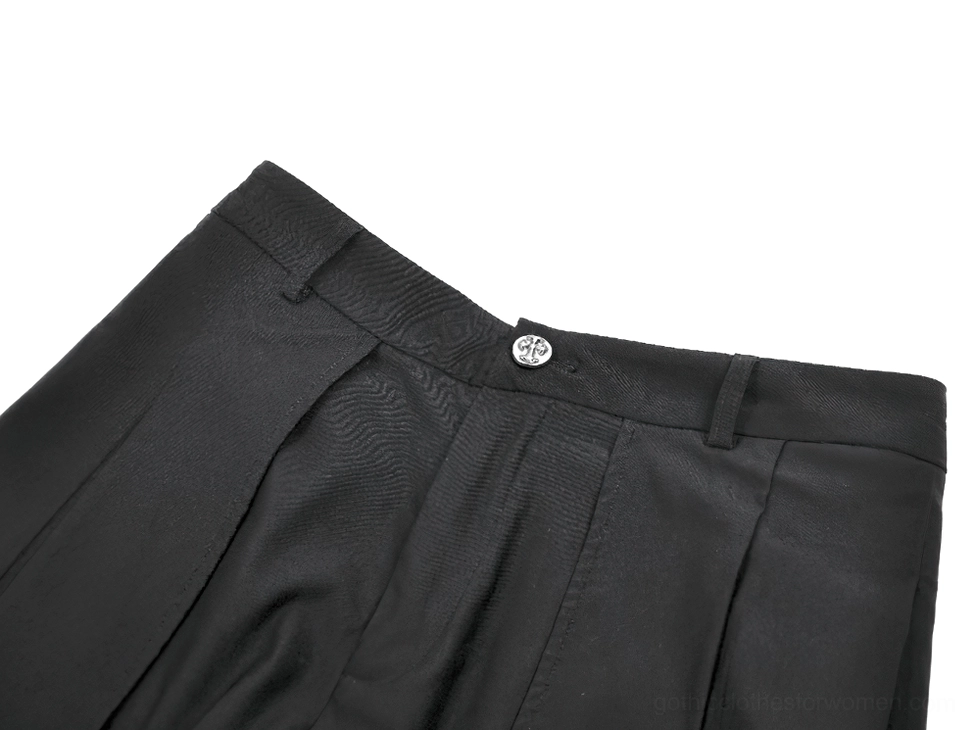 Gothic shorts waistband detail showcasing metal button closure and tailored pleated fabric construction