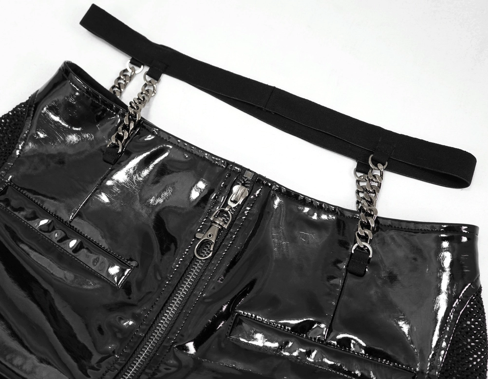 Top-down close-up of black leather shorts showing central spike-trimmed zipper and chain waist straps