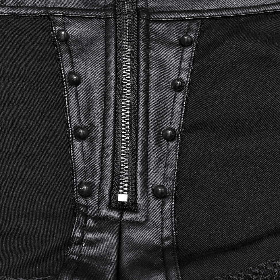 Extreme close-up of black gothic shorts front zipper area showing rivet trims, exposed metal zipper, and decorative hardware details