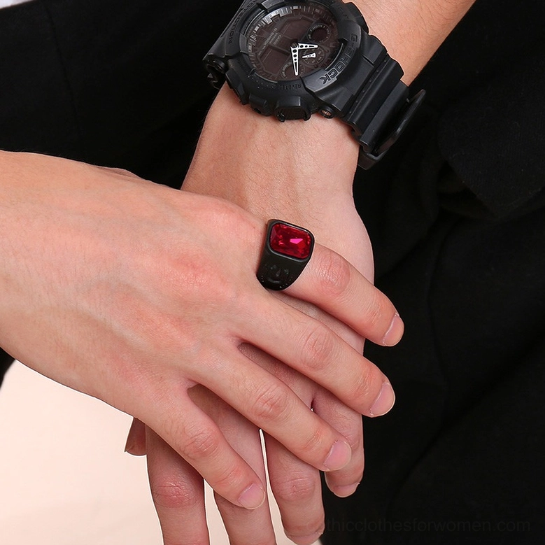 Black gothic ring worn on male hand with sports watch dark background coordinated aesthetic