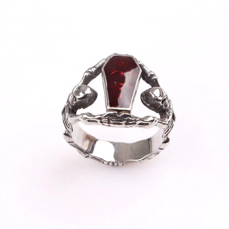 Dual skeleton gothic coffin ring with red rhinestone, top front view showcasing the carved skeleton figures framing the brilliant red stone