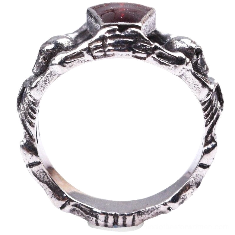 Top-down view of gothic skeleton band ring showing intricate skull design, skeleton arm band, and red stone setting detail