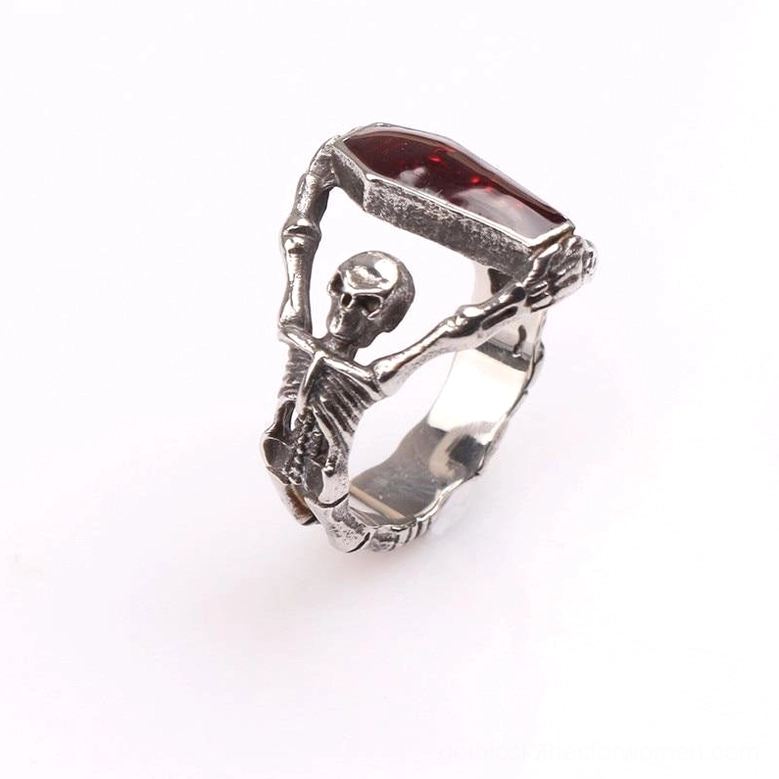 Silver vintage finish gothic skeleton coffin ring oblique view, skeleton hand holding red coffin gem, fine detail photography