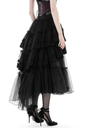 Black layered tulle gothic skirt back view showing dramatic tiered ruffles and high-low asymmetrical hem on model