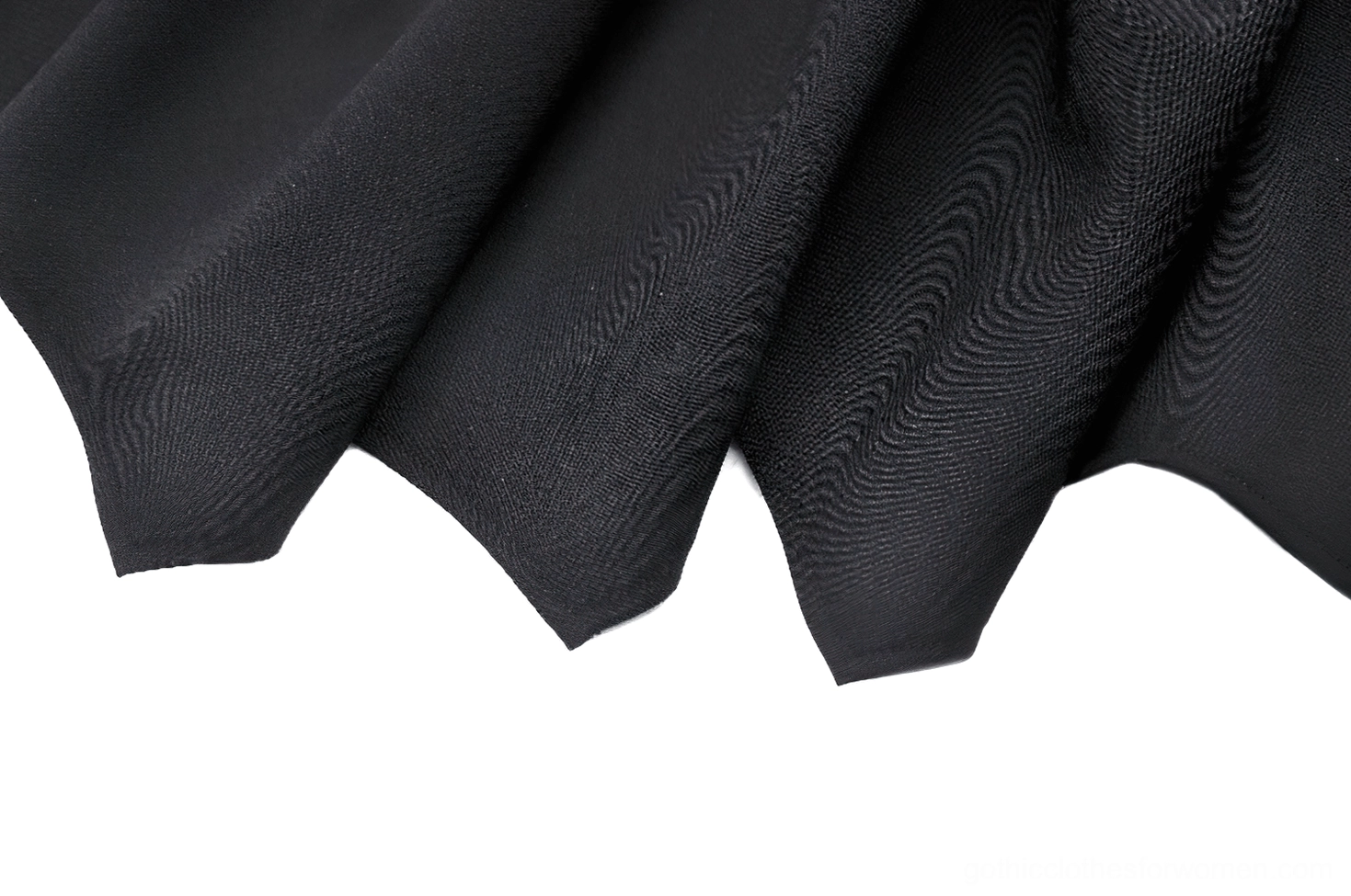 Close-up of black gothic skirt bat wing asymmetrical hem crisp folds detail