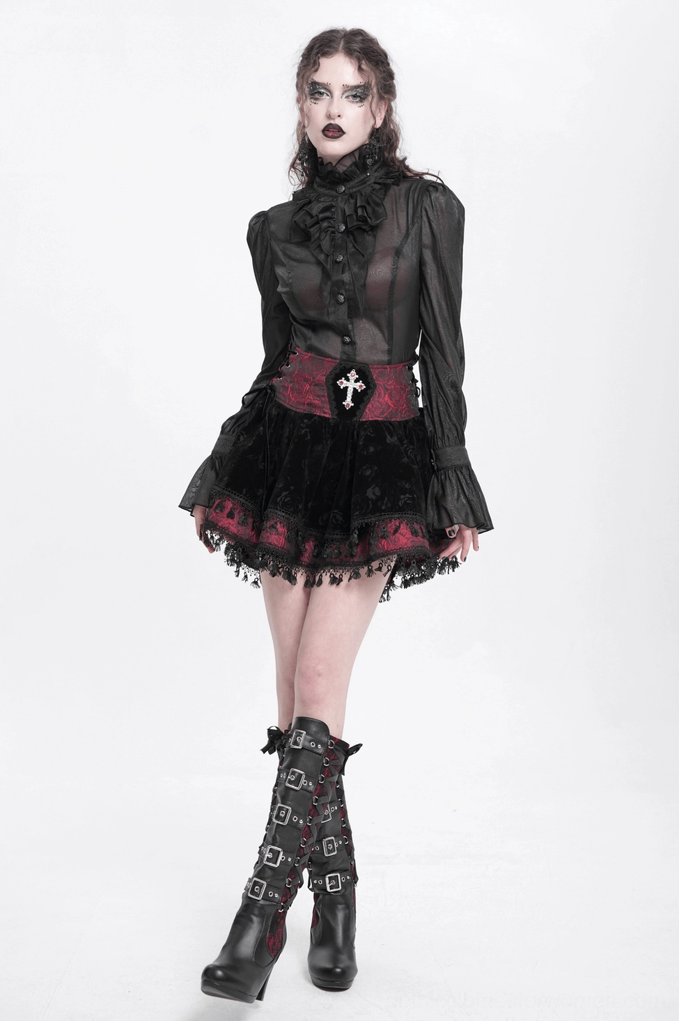 Gothic velvet skirt hem detail showing black lace trim and tassel decoration on wine red fabric