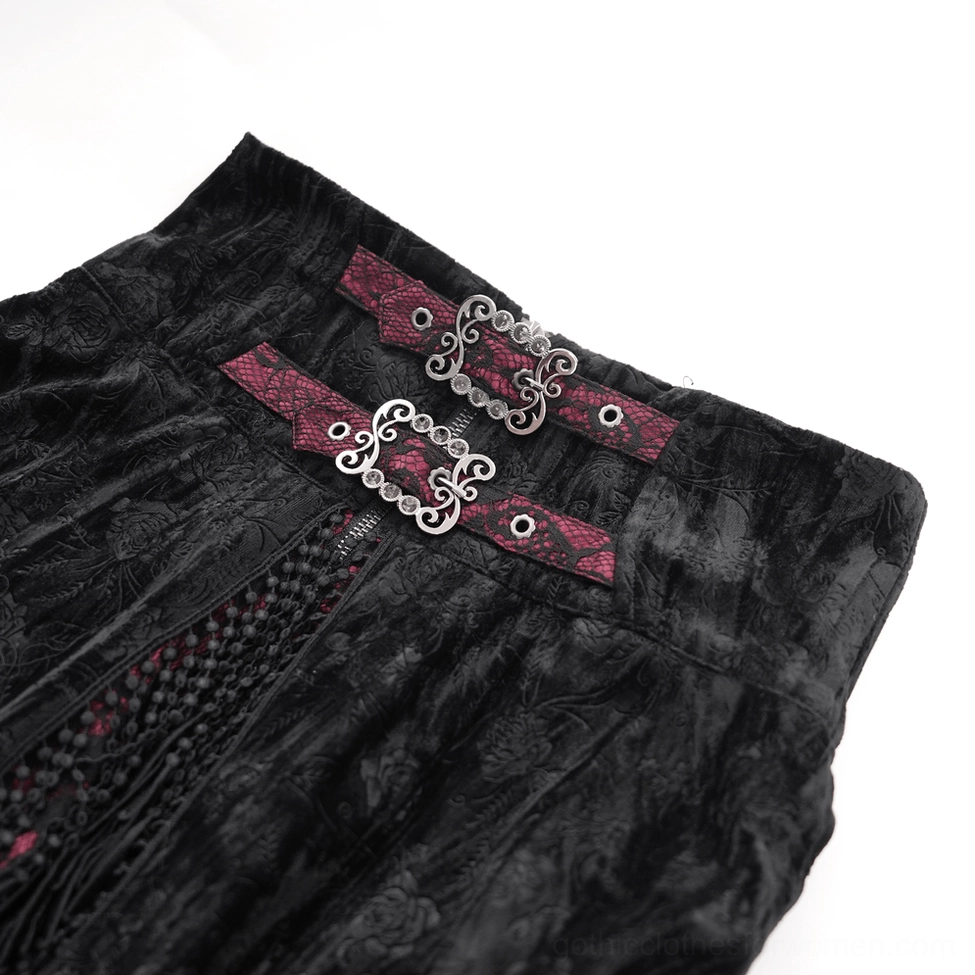 Close-up detail of gothic skirt waistband featuring ornate silver metal buckles, wine red leather straps, and embossed black velvet