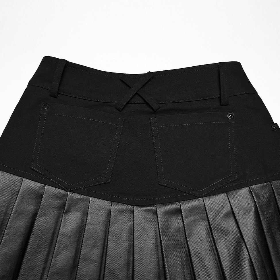Close-up detail of black gothic skirt rear cargo pockets with cross strap design, black woven waist fabric, belt loops, and pleated faux leather hem